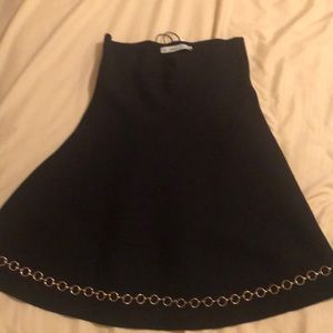 Black skirt with chain at the bottom.